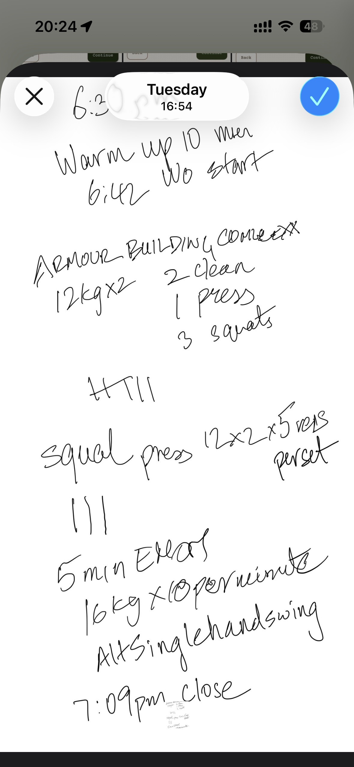 Close view of handwritten kettlebell and dumbbell workout details